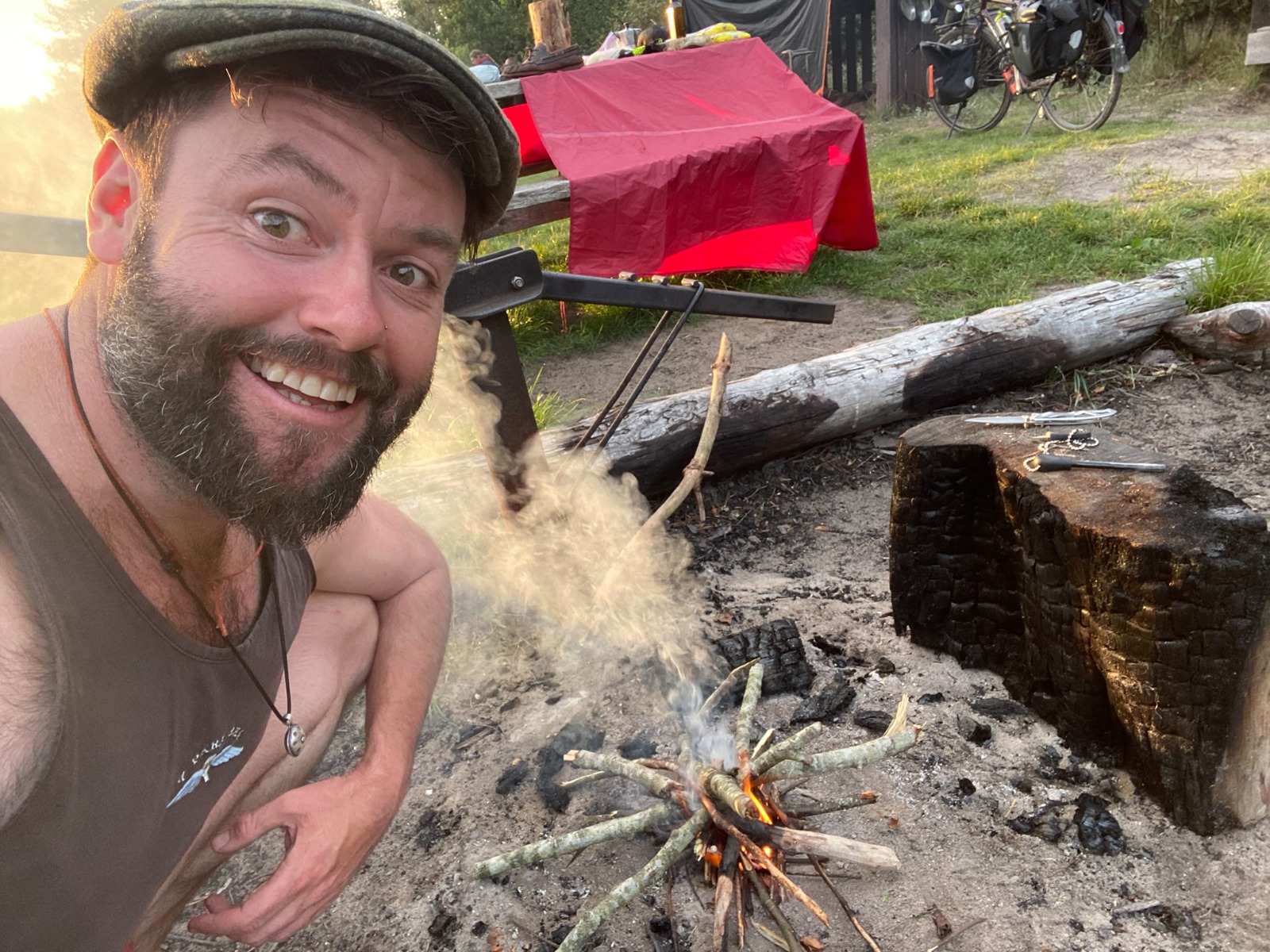 Selfie of a guy beside a fire at a campground