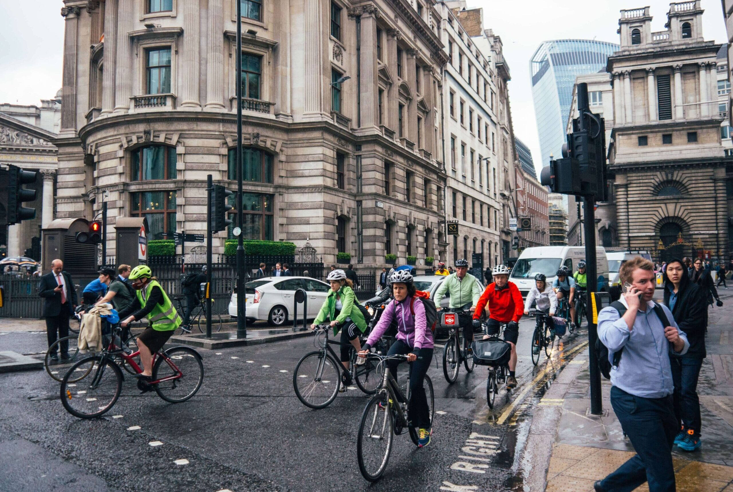 bikes and pedestrians at traffic lights on a rainy london