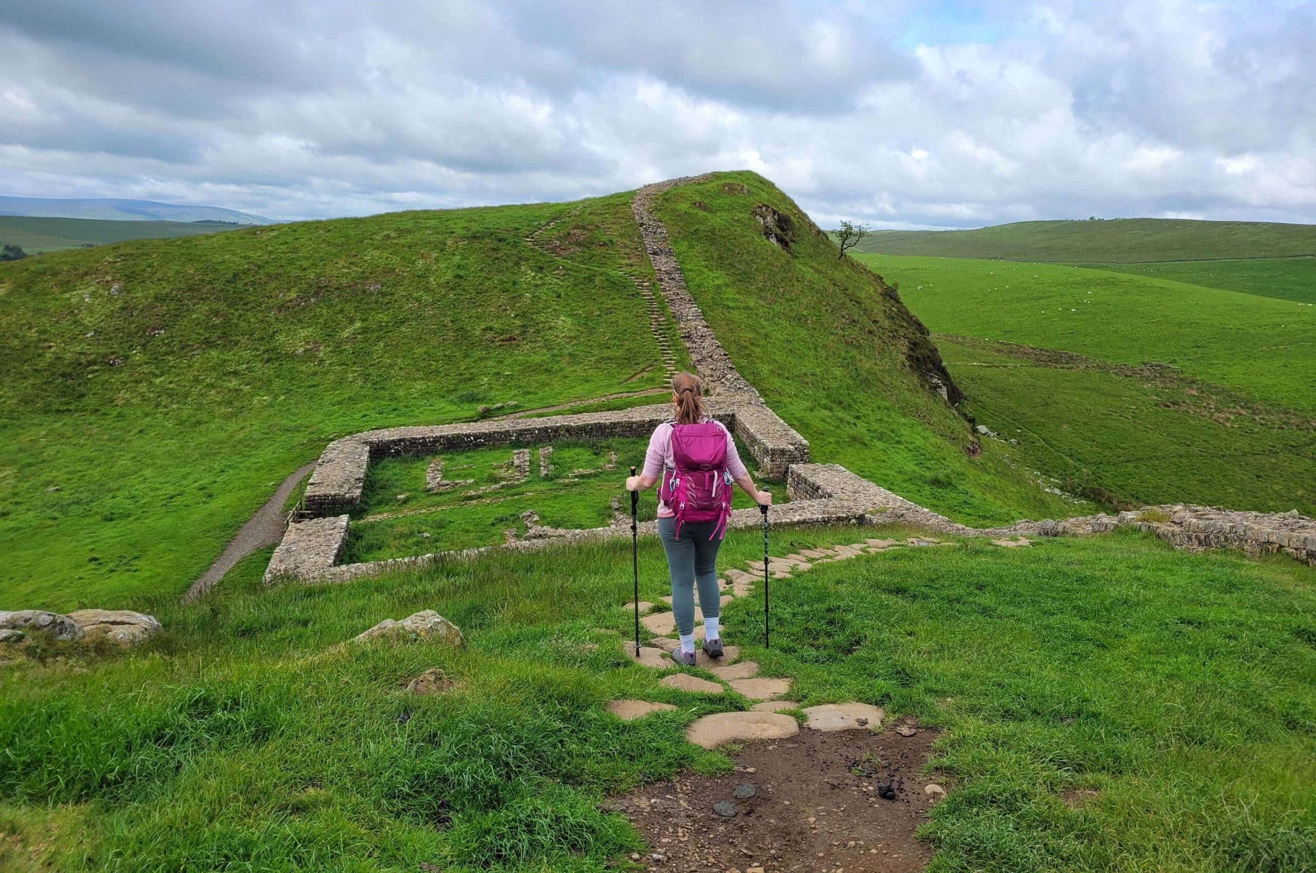 girl walking along Hadrians Wall, northumberland
