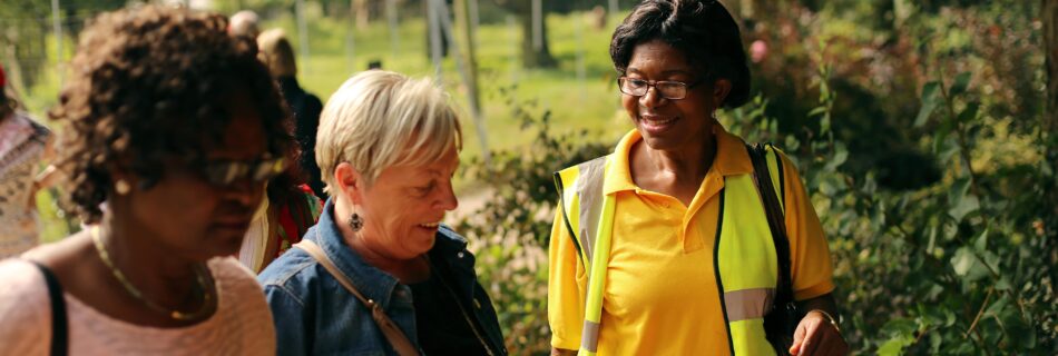A guide and two women on a wellness walk