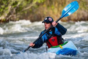 A man kayaking on rapids