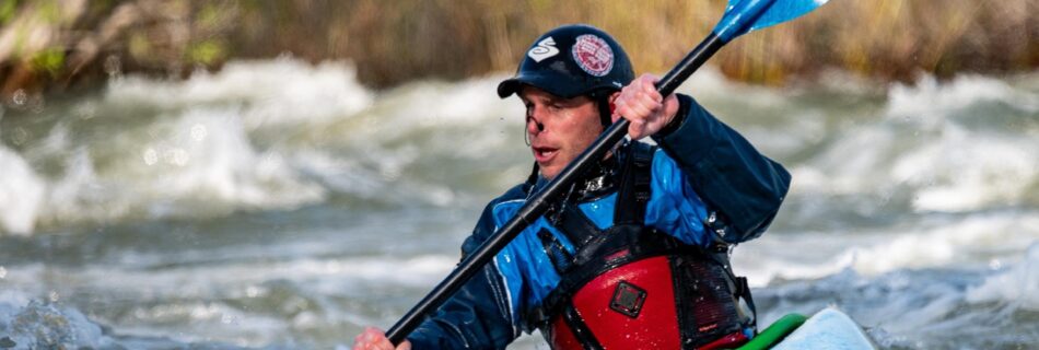 A man kayaking on rapids
